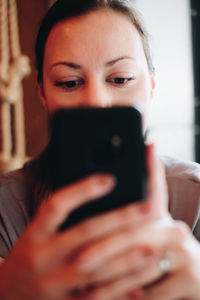 Portrait of young woman using mobile phone