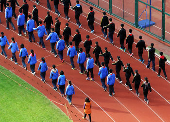 High angle view of people on running track