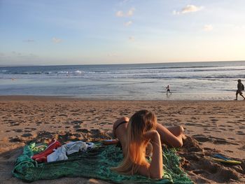 People on beach against sky