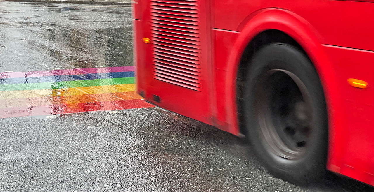 transportation, red, mode of transportation, motor vehicle, city, vehicle, land vehicle, street, road, car, bus, wheel, motion, blurred motion, no people, automotive exterior, truck, transport, wet, speed, tire, day, outdoors, rain