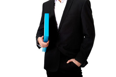 Midsection of man holding umbrella against white background