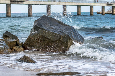 Close-up of groyne in sea against sky