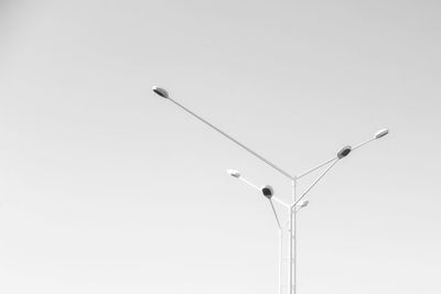 Low angle view of power lines against clear sky
