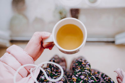 Midsection of woman holding tea cup