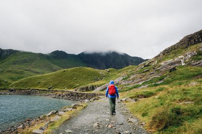 Rear view of woman standing on mountain