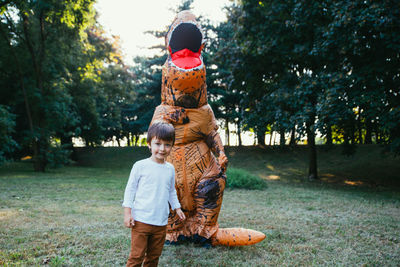 Rear view of mother and son on tree