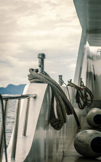 Rope tied to metal structure against sky
