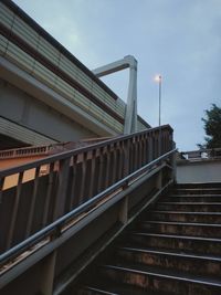 Low angle view of bridge over building against sky