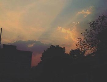 Low angle view of built structure against sky at sunset