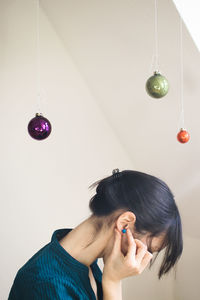 Portrait of woman holding earring 