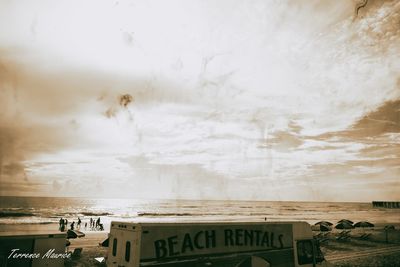 Text on beach against sky