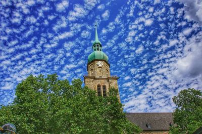 Low angle view of bell tower against sky