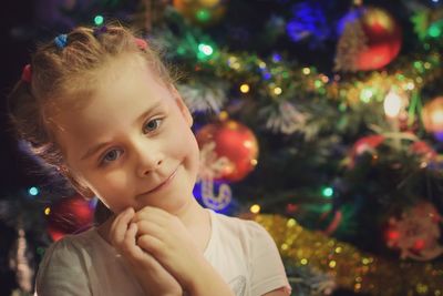 Close-up portrait of girl with christmas tree