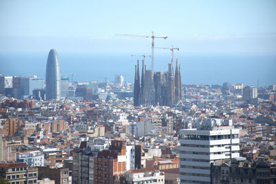 Aerial view of modern buildings in city against sky