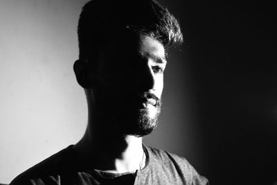 Close-up of thoughtful man in darkroom