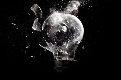 Close-up of broken glass against black background