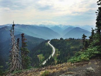 Scenic view of green mountains against sky