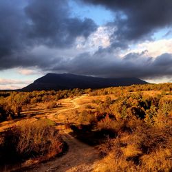 Scenic view of mountains against cloudy sky