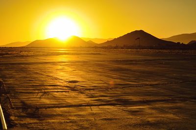 Scenic view of sea against orange sky