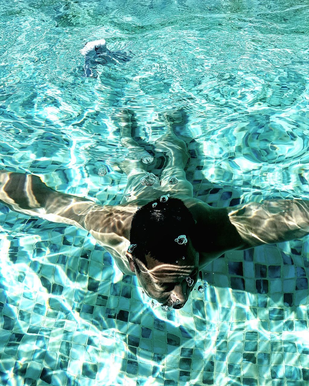 FULL LENGTH OF WOMAN SWIMMING IN POOL