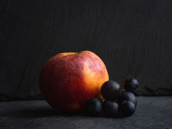 Close-up of apples on table against black background