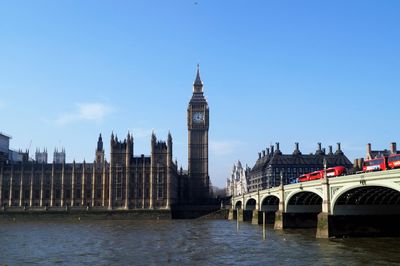 Westminster bridge over thames river against clear sky