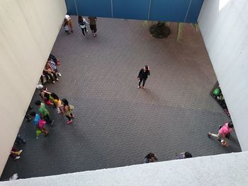 High angle view of people walking on floor