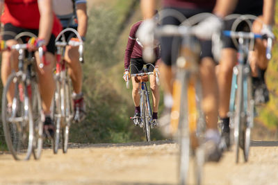 People riding bicycle on road in city