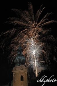 Low angle view of firework display at night