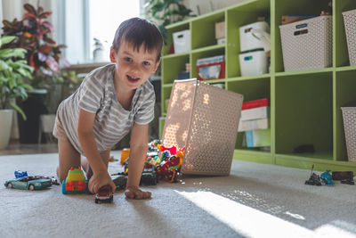 Boy playing with toy blocks at home