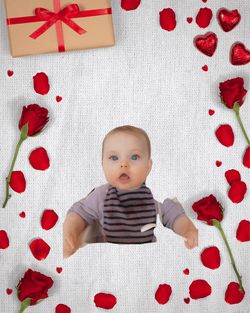 High angle portrait of cute baby lying on bed