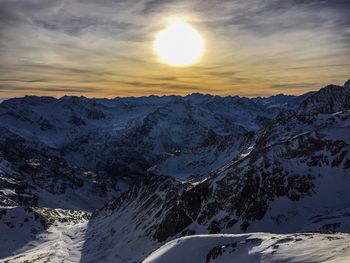 Scenic view of snow mountains against sky during sunset