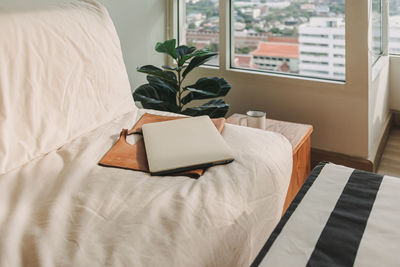 High angle view of laptop on sofa