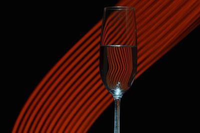 Close-up of beer glass against black background