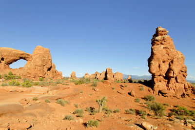 Rock formations against clear blue sky