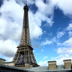 Low angle view of eiffel tower against clouds