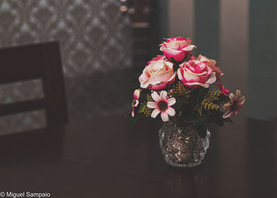 Close-up of pink flower vase on table