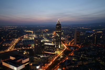 High angle view of city lit up at night