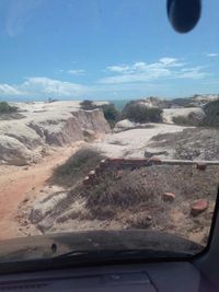 Scenic view of car against sky