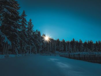 Snow covered landscape against sky at night