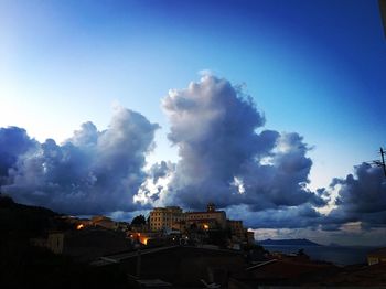 Buildings in city against blue sky