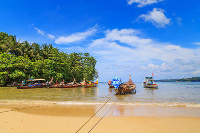 Boats moored on sea against sky