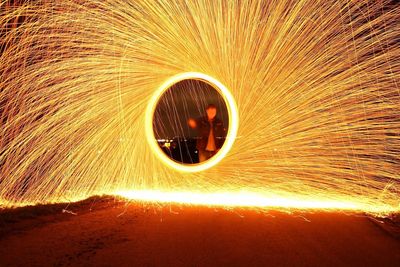 Man standing by wire wool at night