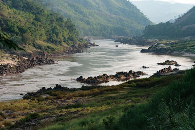 Scenic view of river with mountains in background