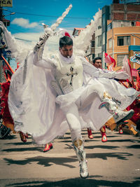 Full length of man with arms raised in city