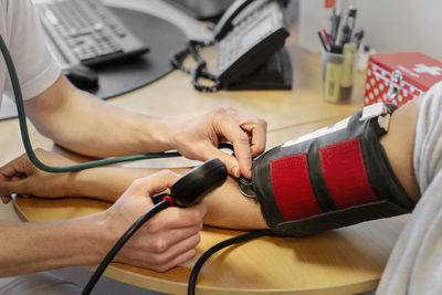 Doctor checking patient's blood pressure