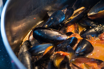 Close-up of cooked mussels in utensil
