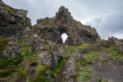 Low angle view of rock formations against sky