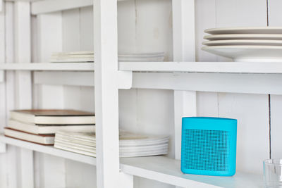 White shelf with wireless speaker