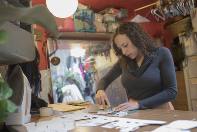 Portrait of young female artist at work in her studio